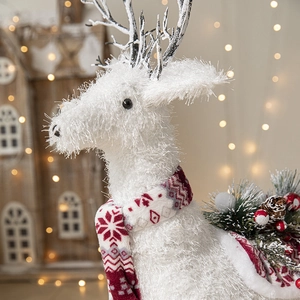 White Christmas reindeer plush ornament with red snowflake scarf and pine cone accents