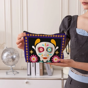 Portable Day of the Dead makeup bag with colorful sugar skull pattern and wrist strap
