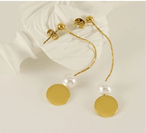Elegant gold titanium long tassel earrings with white pearls on a minimalist bust display