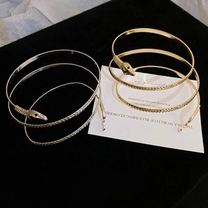 Elegant gold and silver snake spiral cuff bracelets with realistic scale textures