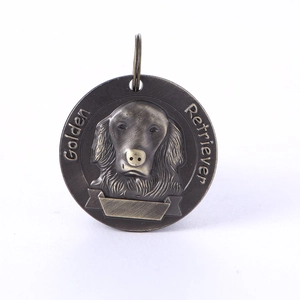 Macro view of bronze Golden Retriever pet ID tag with embossed metal relief and banner