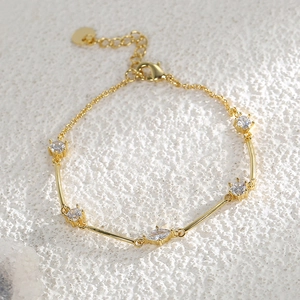Elegant gold plated brass bracelet with zircon stones and a heart charm for women
