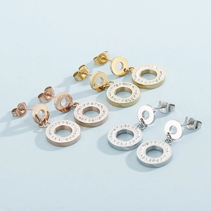 Three pairs of crystal paved round drop earrings in gold, rose gold, and silver finishes