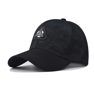 Detail of black baseball cap featuring a triangular Rock logo patch and marble texture