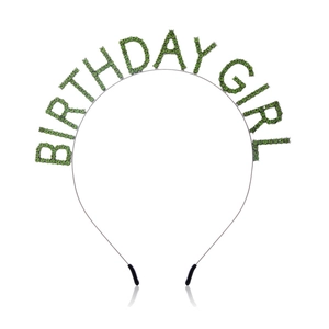 Detail of green rhinestone Birthday Girl headband with polished metal finish on white background