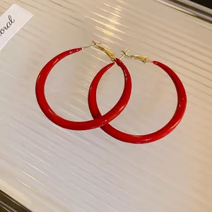 Statement large red enamel hoop earrings with gold-plated clasps for a minimalist bold look