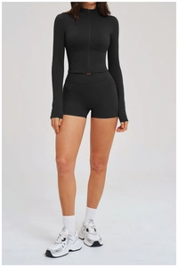Detail of black sports set with zip-up jacket and V-cross high waist yoga shorts