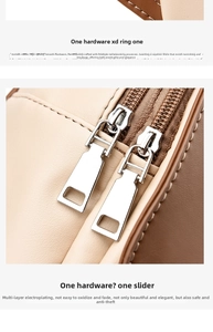 Close-up of gold-plated D-ring and zipper on a contrast leather backpack