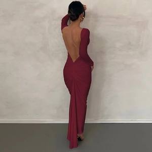 Detail of burgundy backless dress showing elegant ruching and slim-fit long silhouette