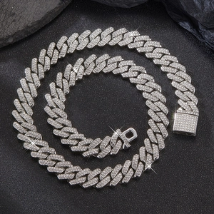 Macro shot of 14mm silver Cuban link necklace with crystal pavé and secure box clasp