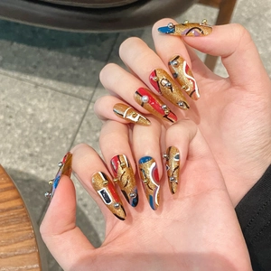 Handmade stiletto press-on nails with abstract colorful patterns and golden glitter
