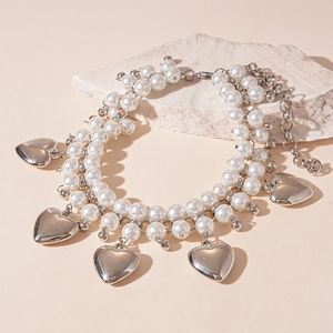 Exaggerated double-layer faux pearl necklace with silver heart pendants on stone base