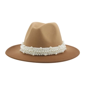 Close-up of white pearl decorative band on a wide brim brown wool fedora hat