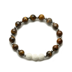 Close-up of natural brown tiger eye beads and white lava stone bracelet with silver spacers