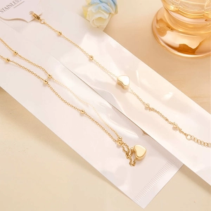 Polished gold stainless steel heart pendant and ball chain necklace and bracelet set