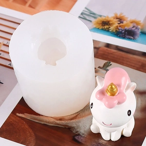 Unicorn silicone mold with finished white plaster craft featuring pink mane and golden horn