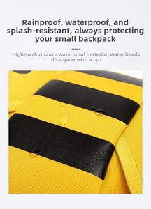 Detail of yellow and black striped fabric with water droplets showing waterproof feature