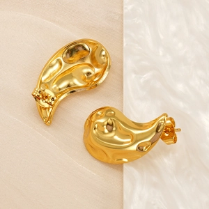 Close-up of golden 18K titanium steel drop earrings with hammered texture finish