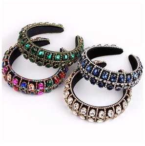 Detailed view of four Baroque headbands with colorful rhinestones on black velvet fabric