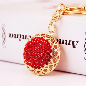 Creative gold-tone round keychain with red rhinestones and lobster clasp for bags