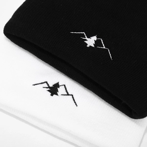 Outdoor knitted beanies in black and white featuring mountain peak embroidery for winter