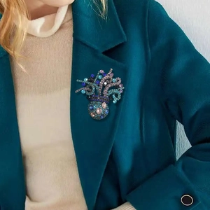 Exquisite octopus brooch with colorful crystals pinned on a dark wool blazer