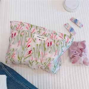 Detailed texture of jacquard fabric makeup bag with floral pattern and simple wish label