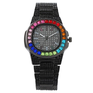 Luxury black crystal watch with rainbow gemstone bezel and calendar display on white backdrop