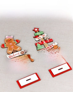 Detail of wooden gingerbread man and Christmas tree desk ornaments with red base