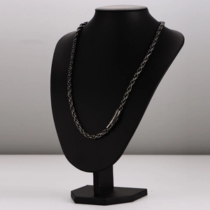 Vintage braided twisted stainless steel necklace with double cross on black bust model