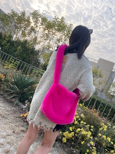 Detailed close-up of a vibrant hot pink faux fur tote bag showing plush texture on shoulder