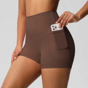 Detail view of high-waisted yoga shorts with functional side pocket for smartphone