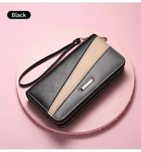 Detail of black double zipper long wallet with detachable wrist strap on pink stand