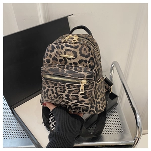 Close-up of leopard print mini backpack with metal zippers and adjustable straps