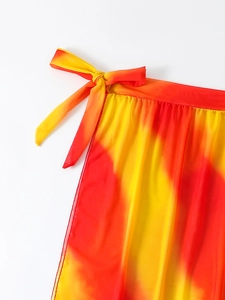 Close-up of lightweight yellow and orange tie-dye beach wrap with waist tie detail
