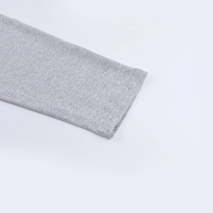 Close-up of grey knit fabric texture and fine stitching on the athletic yoga set cuff