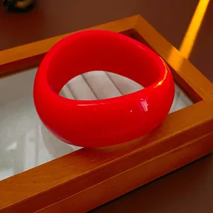 Polished glossy red irregular wavy wide bangle bracelet with artistic light and shadow