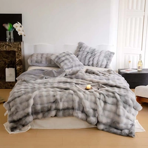 Detailed macro view of the thick plush faux fur texture and grey gradient stripe blanket