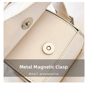 Detailed close-up of a high-quality magnetic metal clasp on a cream-colored PU leather bag