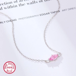 Macro shot of S925 silver necklace with pink marquise gemstone and white crystals