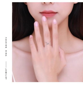 Detailed view of elegant silver S925 cross geometric open ring on a model hand