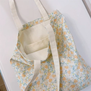 Macro view of floral canvas tote bag interior showing capacity and inner pocket