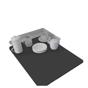 Absorbent black diatomite drying mat for kitchen counters with white ceramic tea set