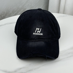 Close-up of black cotton baseball cap featuring MJ FASHION embroidery and distressed brim detail
