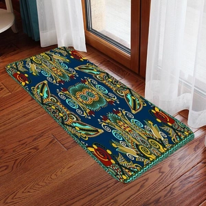 Detail of bohemian runner rug with navy owl pattern on dark wood flooring indoors