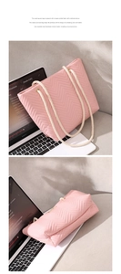 Close-up of pink herringbone quilted tote bag with white rope handles and gold eyelets
