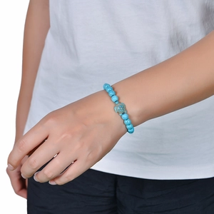 Natural turquoise and lava stone turtle bead bracelet with elastic cord on wrist