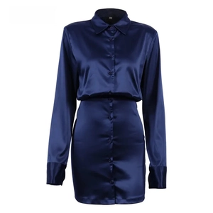 Flat lay of a navy blue satin shirt dress with button details and long sleeves