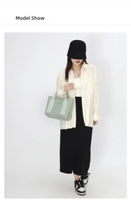 Light green canvas tote bag styled with a cream blouse and black skirt for casual outfit