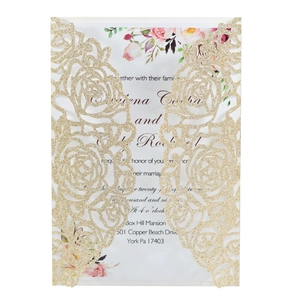 Detail of gold glitter laser cut floral wedding invitation with watercolor insert card